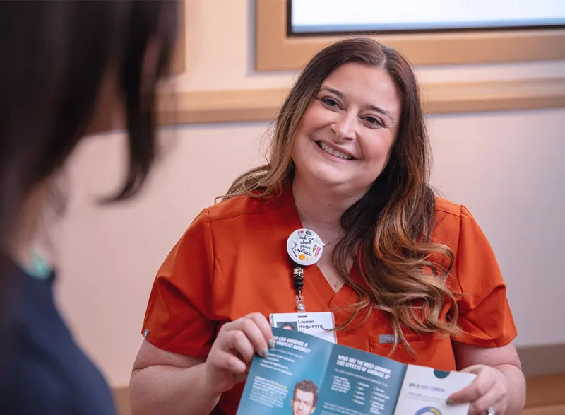 Clinician reviewing health education brochure with patient.